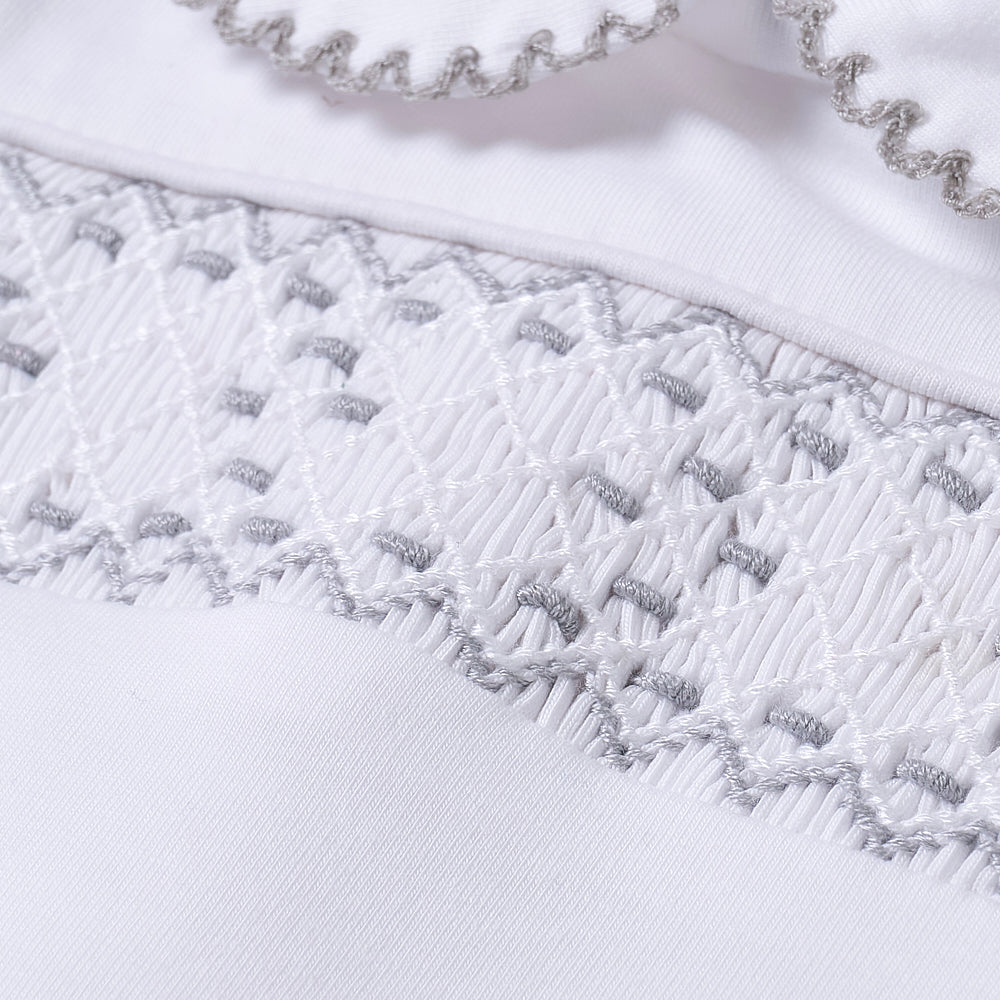 Hand smocked cotton babygrow with grey details